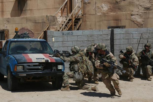 Infantrymen from the 3rd Infantry Division’s 2nd Armored Brigade Combat Team sprint from behind cover during a May 8 urban battle at the National Training Center at Fort Irwin, California. Matthew Cox/Military.com