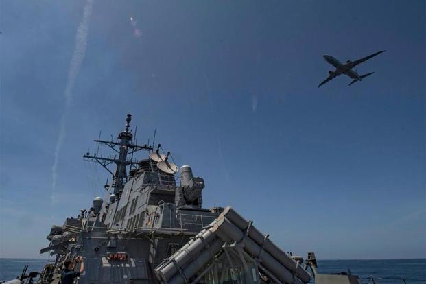 A P-8 Poseidon flies over the Arleigh Burke-class guided-missile destroyer USS Carney during an air defense exercise. (U.S. Navy/Twitter)