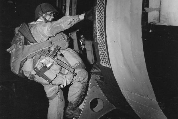 A paratrooper with a Thompson M1 submachine and heavy equipment. (Image: The National WWII Museum)