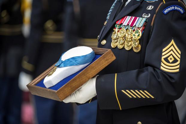 U.S. Army first sergeant holds the Medal of Honor during an Enshrinement Ceremony at the Smithsonian National Postal Museum in Washington, D.C. (Getty Images)