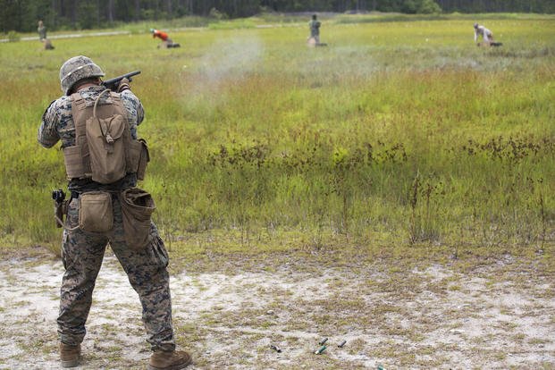 Lance Cpl. Levi Burton with 2nd Law Enforcement Battalion, II Marine Expeditionary Force Information Group, fires a 12-gauge shotgun during a live-fire range, testing a new autonomous robotic target system at Camp Lejeune, N.C., on June 26, 2018. The Marines used the targets to further develop their marksmanship skills, anticipate natural movement and increase combat effectiveness. (U.S. Marine Corps photo by Lance Cpl. Tanner Seims)