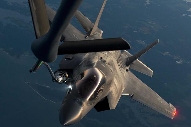 An F-35B is drogue refueled by a KC-135 during an evening flight test August 2014 near Naval Air Station Patuxent River, Maryland. Teams from Pax River and Edwards Air Force Base, California, completed testing in March on an improved probe light assembly for the F-35B and F-35C to enhance visibility for KC-135 boom operators during night refueling. Photo by Dane Wiedmann via DVIDS