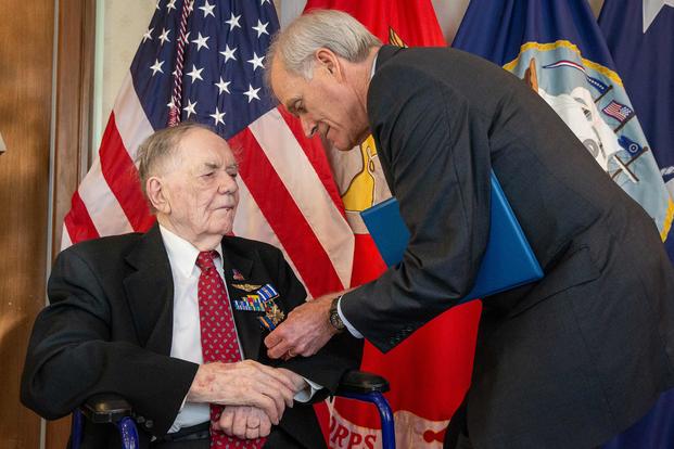 On Sept. 10, 2019, Navy Secretary Richard V. Spencer awards retired Aviation Machinist's Mate 1st Class Bernard B. Bartusiak, 95, with two Distinguished Flying Cross medals and the Air Medal (Strike/Flight), 2nd-8th awards, for meritorious service during World War II involving aerial flight from April 20, 1943, to August 26, 1944. (U.S. Navy photo by Mass Communication Specialist 1st Class Paul L. Archer)
