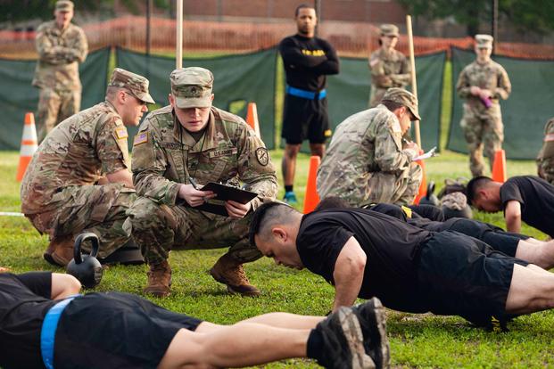 Staff Sgt. Gabriel Wright, a signals intelligence analyst with the 780th Military intelligence Brigade, grades the Hand-Release Push-Up event May 17, 2019, as part of Army Combat Fitness Test Level II Grader validation training, held at Fort Meade, Maryland. (Army photo by Sgt. 1st Class Osvaldo Equite)