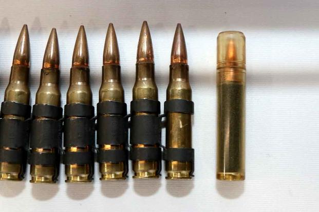 This is Textron System's Next Generation Squad Weapon's 6.8mm cartridge that features its signature, plastic case-telescoped design. (Military.com/Matthew Cox)