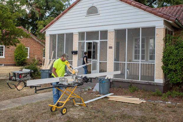 Workers install new windows at one of Fort Benning's many historic homes on Oct. 1, 2019, as part of a broader effort underway since about a year ago to curb lead-based paint hazards in the historic homes. In addition, officials have in the past year introduced stringent new repair and inspection practices and hired more housing staff, and senior leadership is keeping strong emphasis on making housing service efficient, transparent and responsive to residents. (Patrick A. Albright/U.S. Army)