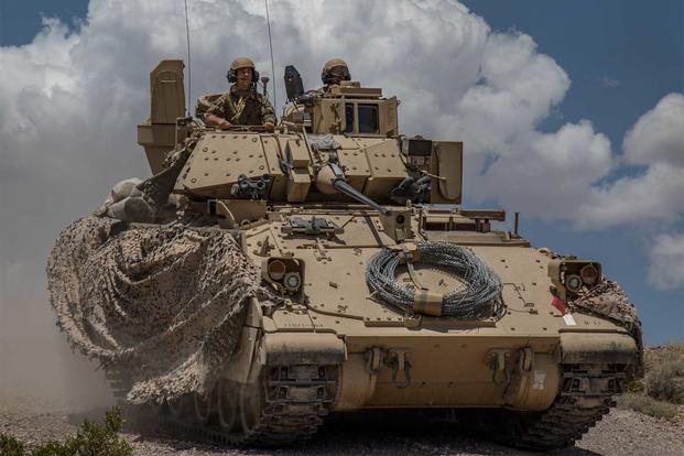 Soldiers from 1st Battalion, 163rd Cavalry Regiment, Montana Army National Guard, push on in their Bradley Fighting Vehicle during a defensive attack training exercise at the National Training Center (NTC) in Fort Irwin, Calif., June 1, 2019 (Cpl. Alisha Grezlik/115th Mobile Public Affairs Detachment)