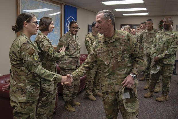 Air Force Chief of Staff Gen. David L. Goldfein presents a coin to U.S. Air Force Master Sgt. Bridget Baydal, logistics team sergeant assigned to the 818th Mobility Support Advisory Squadron, during their visit to the U.S. Air Force Expeditionary Center as part of 2019 Fall Phoenix Rally, Oct. 9, 2019, at Joint Base McGuire-Dix-Lakehurst, New Jersey. Fall Phoenix Rally is a three-day summit focused on understanding leadership roles in emerging issues with Air Mobility Command, bringing together leadership a