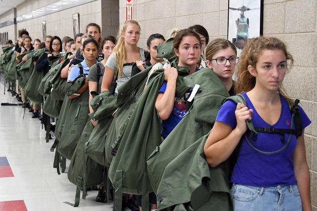 Naval Reserve Officers Training Corps (NROTC) midshipmen candidates line up to be issued clothing items as part of “Ditty Bag” issue in the Golden 13 Recruit In-processing Center at Recruit Training Command (RTC), July 24, 2019. (U. S. Navy photo/Scott A. Thornbloom)