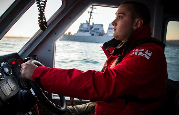 A sailor drives a harbor pilot