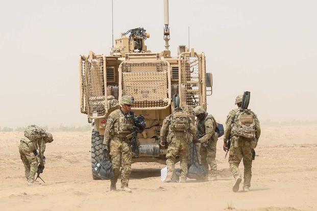 Army soldiers unload humanitarian aid supplies in Afghanistan.