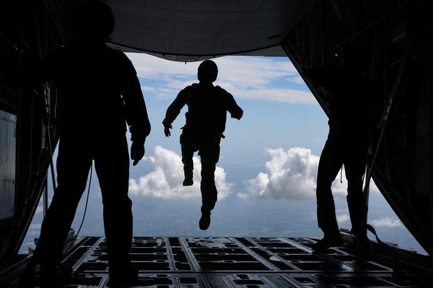 An Airman assigned to the 57th Rescue Squadron begins a freefall jump from a 37th Airlift Squadron C-130J Super Hercules during exercise Ares Shadow, Aug. 11., 2017. (U.S. Air Force/Airman 1st Class Eli Chevalier)