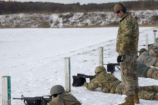 U.S. Army Staff Sgt. Edward French, a team sergeant in Alpha Company, 414th Civil Affairs Battalion, watches another Soldier's shooting technique while they fire at a zeroing target at Fort Custer, Michigan, Nov. 16, 2019. (U.S. Army/ Sgt. Adam Parent)