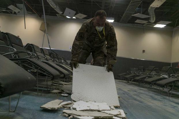 U.S. Air Force Tech. Sgt. Ryan Schell clears debris inside the passenger terminal the day after a Taliban-led attack at Bagram Airfield, Afghanistan, Dec. 12, 2019. (U.S. Air Force/Airman 1st Class Brandon Cribelar)