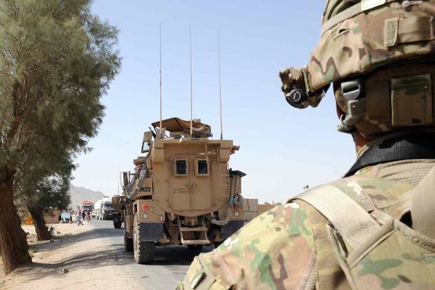 A U.S. Army Soldier stands perimeter watch amid a convoy of MRAP vehicles during a Key Leader Engagement between members of Provincial Reconstruction Team Farah and the Farah Director of Transportation (U.S. Army/Sgt. Maj. Concordio Borja Jr.)