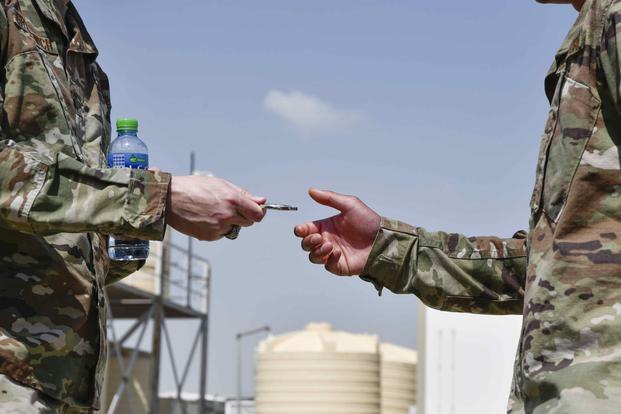 An Airman gets coined for excellence during at Cargo City, Kuwait, March 17, 2020.