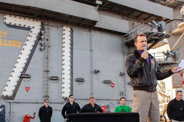 Capt. Brett Croziergives remarks during an all-hands call on the ship’s flight deck.