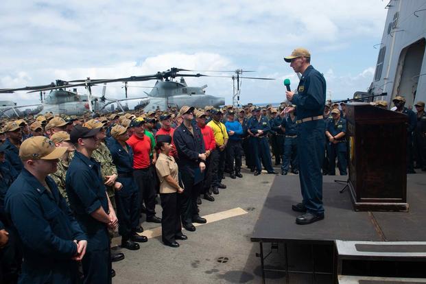 The commanding officer of the USS Green Bay speaks to sailors at an all-hands call.