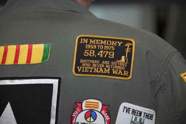 A memorial patch is worn by a Vietnam veteran.