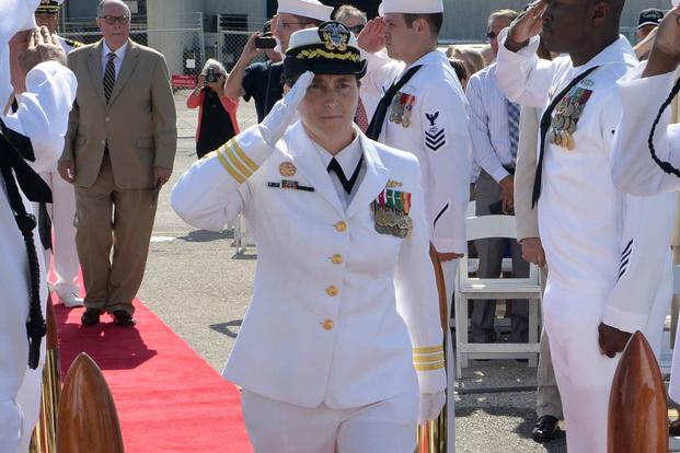 Cmdr. Erica Hoffmann enters the decommissioning ceremony of Samuel B. Roberts.