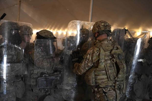 A U.S. Army military police company participates in non-lethal riot training with riot shields and gas masks, Nov. 25, 2018, at Camp Donna.