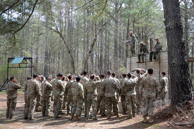 Instructors teach students how to friction-rapel during SERE training at Camp Mackall.