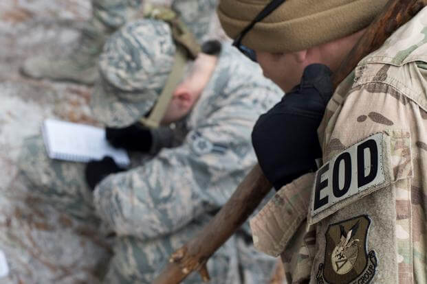 An explosive ordnance disposal technician reviews nine-line notes during counter-improvised explosive device training.