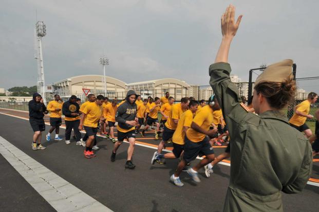 Sailors run their 1.5 mile run during a physical readiness test.