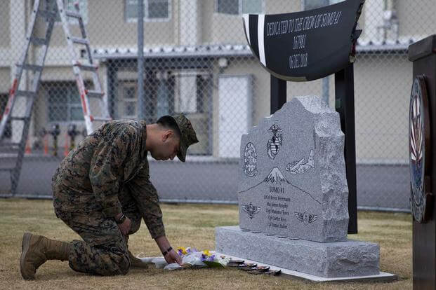 U.S. Marine Corps Sgt. Alberto Ruiz honors the fallen during the unveiling of a memorial for the five Marines of Sumo-41.