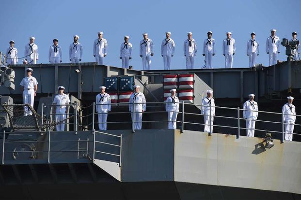 Sailors aboard USS George H.W. Bush man the rails.