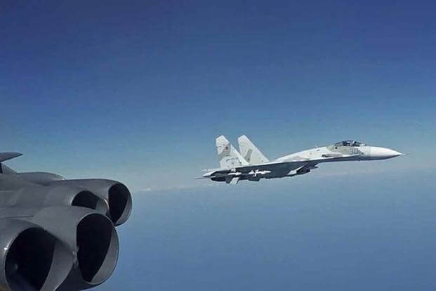 A Russian Su-27 Flanker jet intercepts a U.S. Air Force B-52 bomber