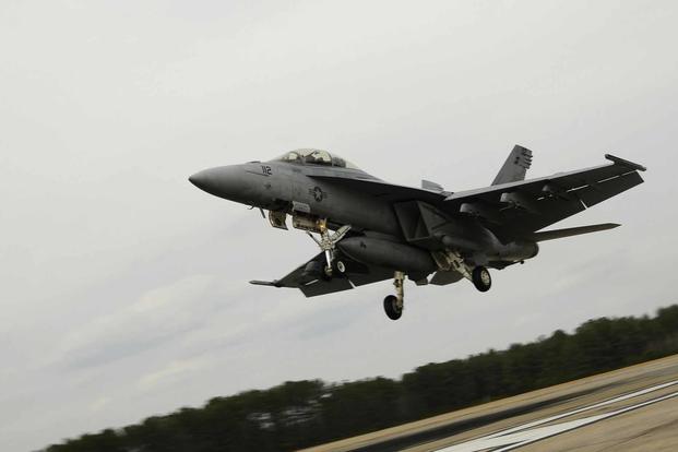 An F/A-18F Super Hornet conducts carrier landing simulations at Fentress.