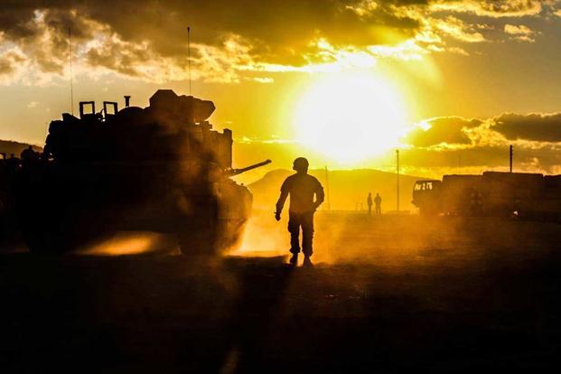 Soldier watches sun set at Fort Knox.