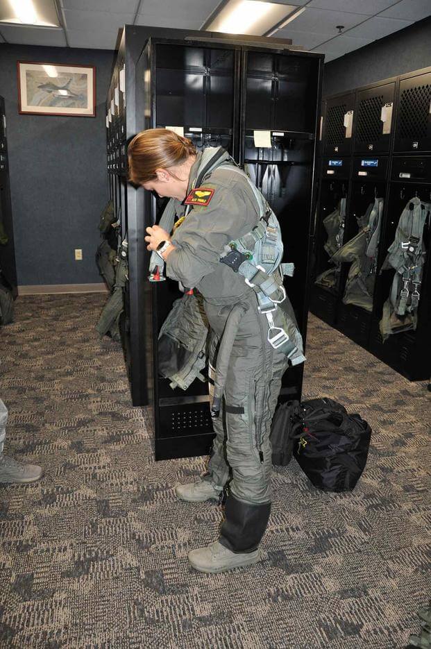 Capt. Brittany Trimble, F-16 instructor pilot, dons her flight gear, including the modified ATAGS