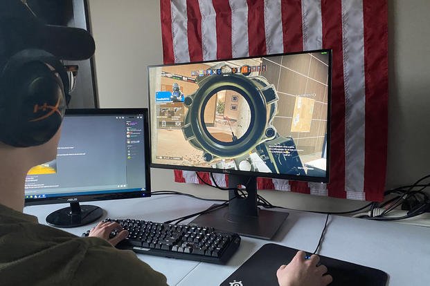 service member playing esports