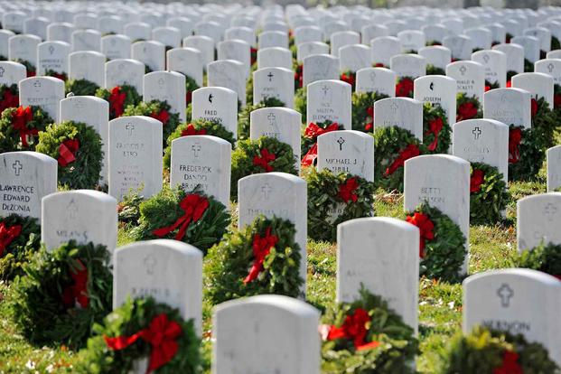 Wreaths lay on the graves of fallen service members at Arlington National Cemetery 