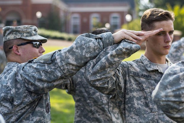 ROTC cadet is shown how to salute properly