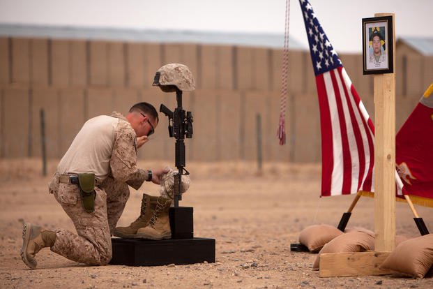 Marine during a memorial service in Afghanistan