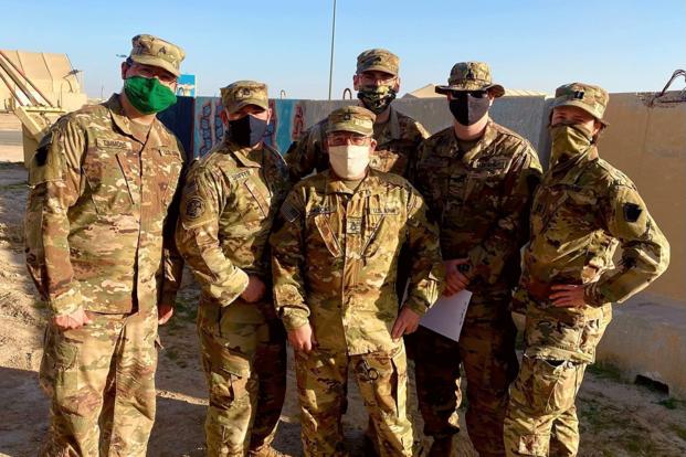 U.S. soldiers in Kuwait pose before getting the COVID-19 vaccine.
