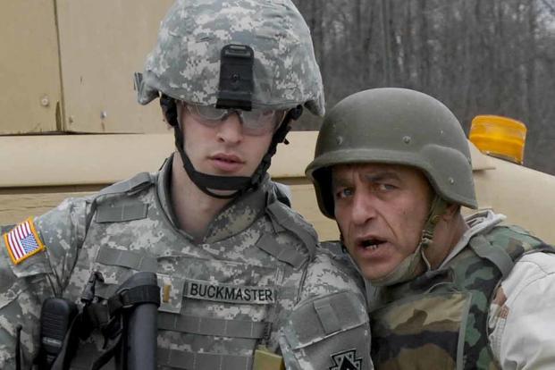 Soldier talks with his Afghan interpreter.