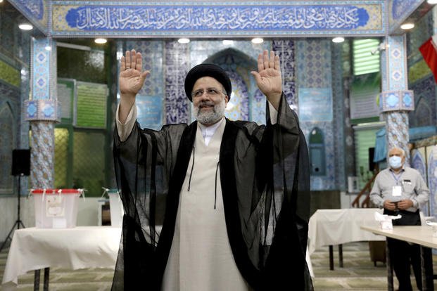 Ebrahim Raisi, a candidate in Iran's presidential elections waves to the media.