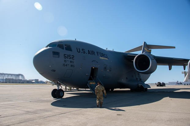 Air National Guard member prepares to board C-17 Globemaster.