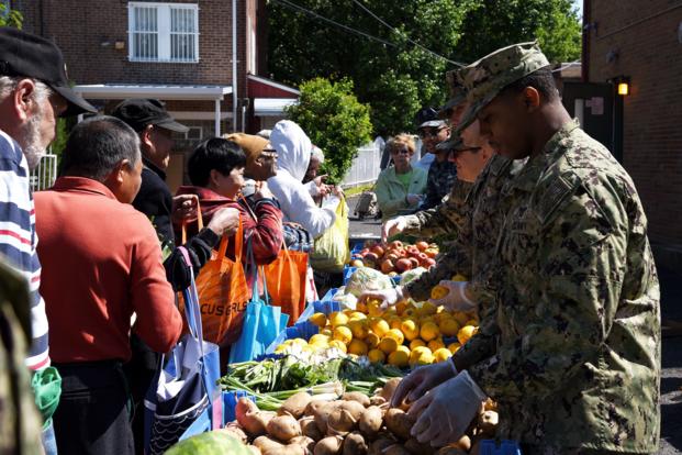Sailors hand out food to local families during a community relations event at a Salvation Army site in Philadelphia in 2019