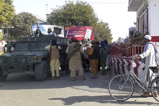 Taliban fighters stand guard in Kunduz city