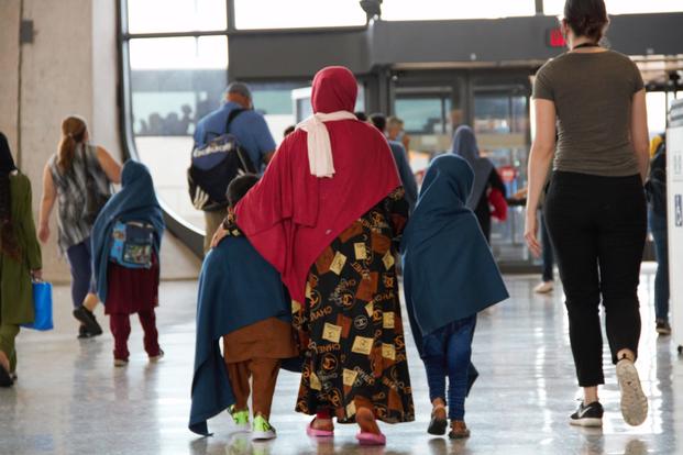 Afghan refugees leave the screening location in Dulles airport.