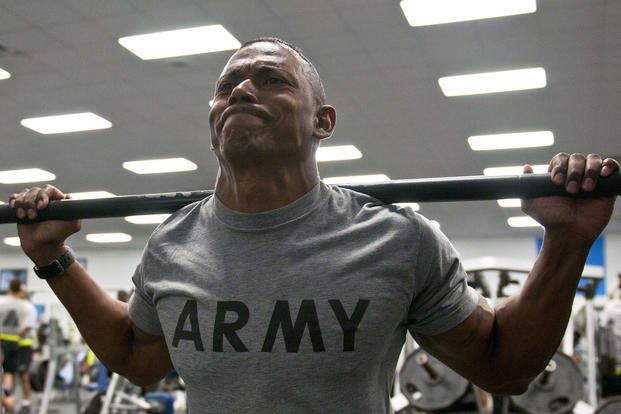 An Army sergeant squats at Fort Hood.