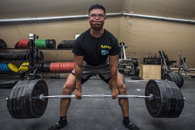 Senior airman performs deadlift during weightlifting competition.
