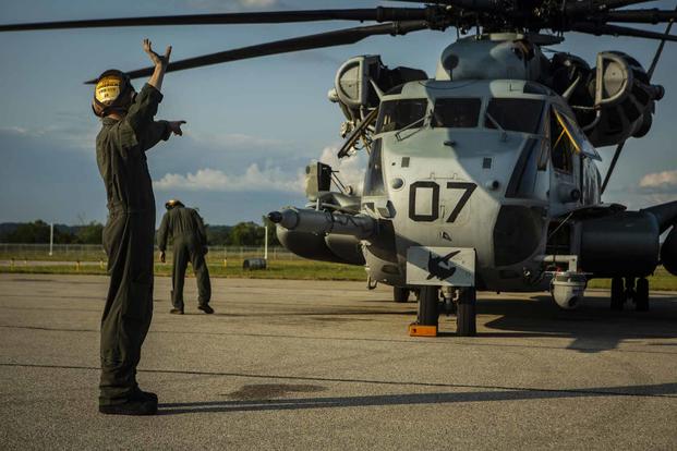 U.S. Marines conduct maintenance on a CH-53E Super Stallion