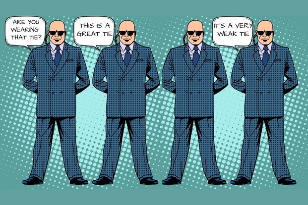 four bald men in ties and suites tell lies