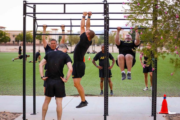 Soldiers perform pull-ups during physical training.